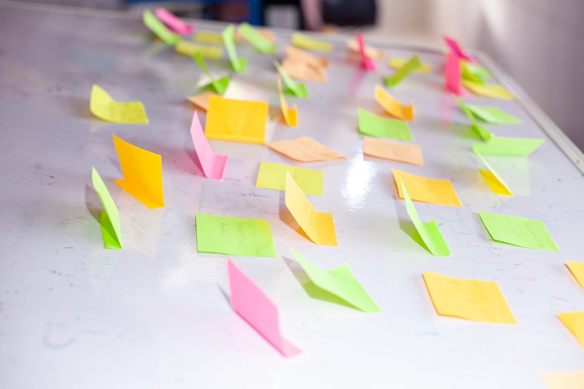 Colorful sticky notes scattered on a whiteboard — brainstorming session